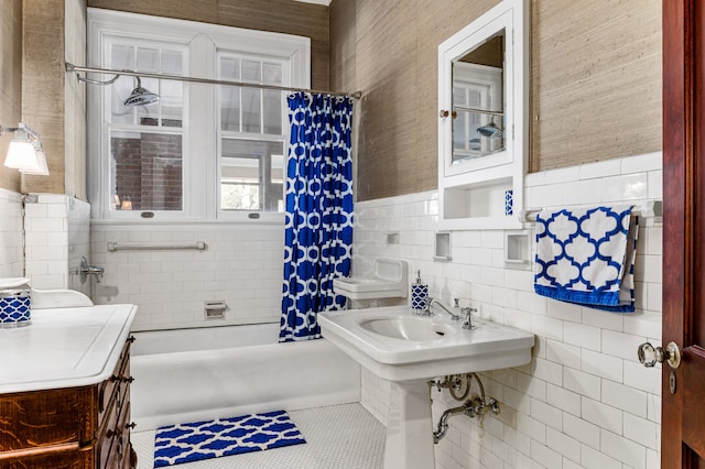 bathroom with tile walls, backsplash, tile floors, and shower / bath combo