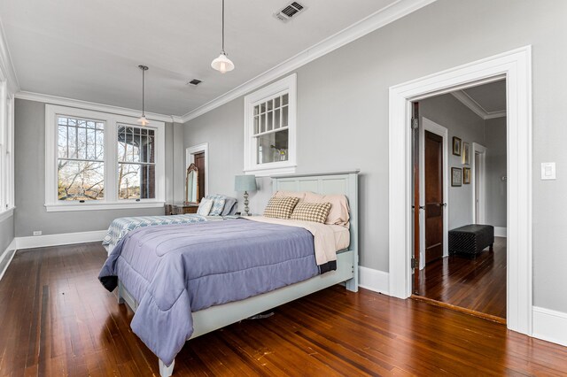 bedroom with dark hardwood / wood-style flooring and ornamental molding