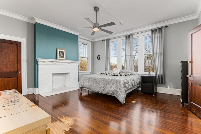 bedroom featuring crown molding, dark hardwood / wood-style floors, ceiling fan, and a brick fireplace