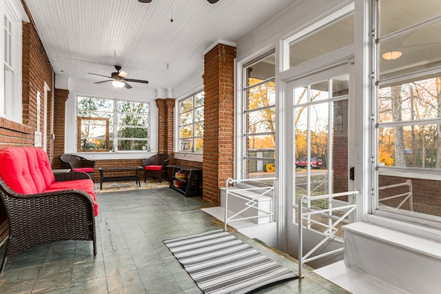 sunroom / solarium featuring ceiling fan