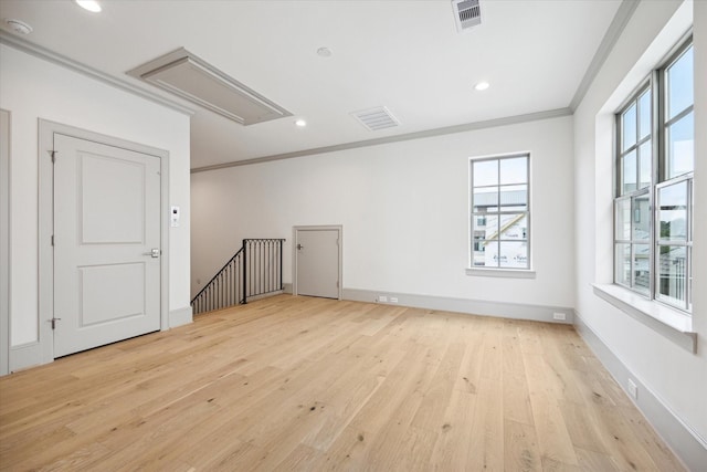 unfurnished room with attic access, crown molding, light wood-style floors, recessed lighting, and baseboards
