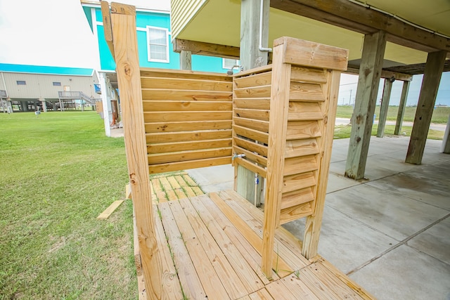 wooden deck with a yard and a patio