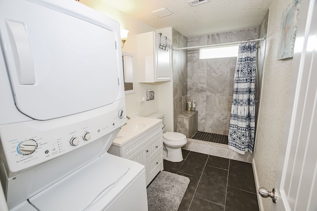 bathroom featuring vanity, stacked washing maching and dryer, curtained shower, tile flooring, and toilet