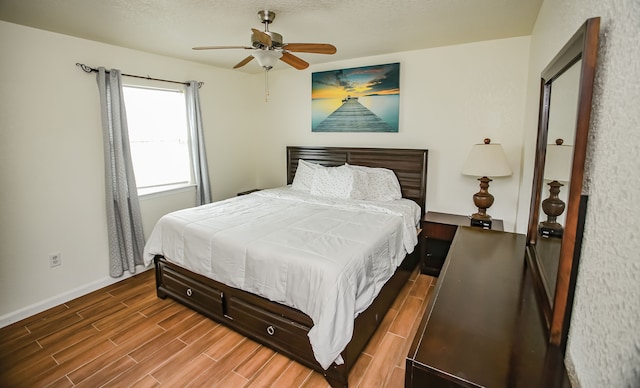 bedroom with ceiling fan and hardwood / wood-style flooring