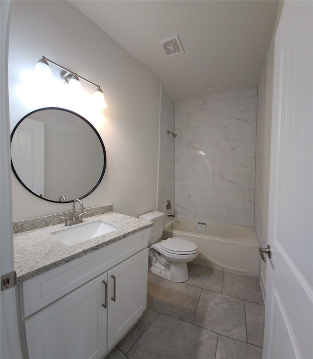 full bathroom with tiled shower / bath, toilet, tile flooring, and vanity