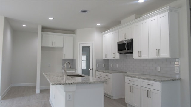 kitchen featuring white cabinets and sink