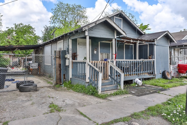 bungalow-style home featuring a carport and covered porch