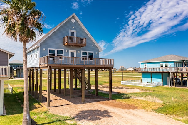 rear view of property featuring a wooden deck and a yard