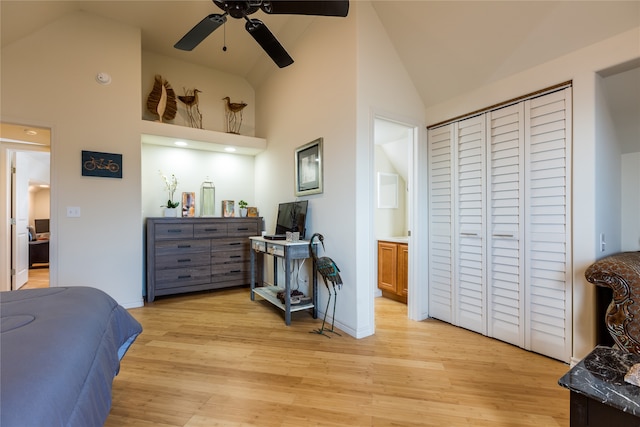 bedroom with light hardwood / wood-style flooring, ceiling fan, a closet, and high vaulted ceiling