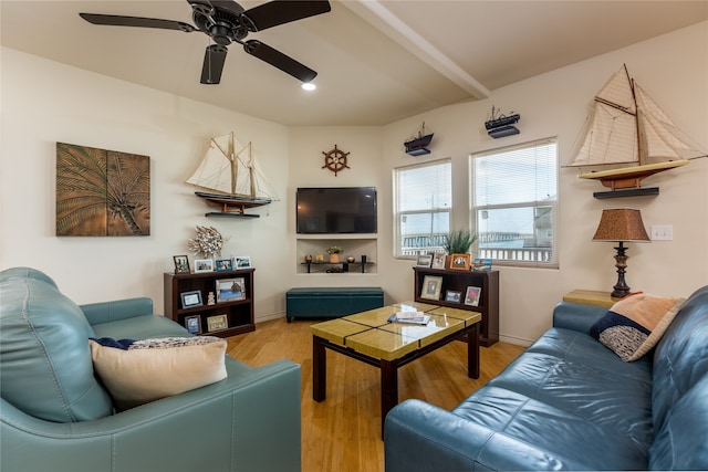 living room featuring ceiling fan, beamed ceiling, and light hardwood / wood-style floors