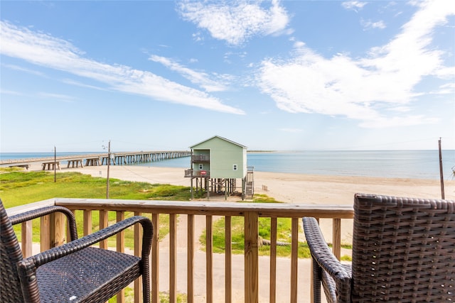 balcony featuring a water view and a view of the beach