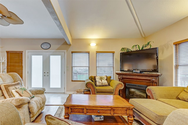 living room with ceiling fan, vaulted ceiling with beams, light tile floors, and french doors