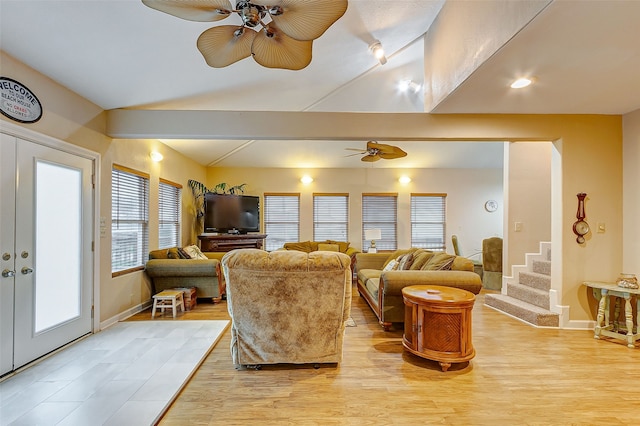 living room with ceiling fan, light hardwood / wood-style flooring, and french doors