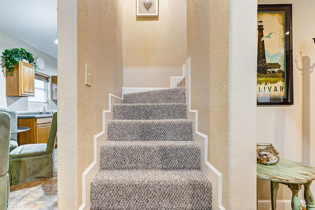 stairs featuring light tile flooring