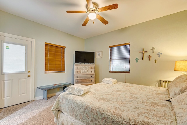 bedroom featuring light colored carpet and ceiling fan