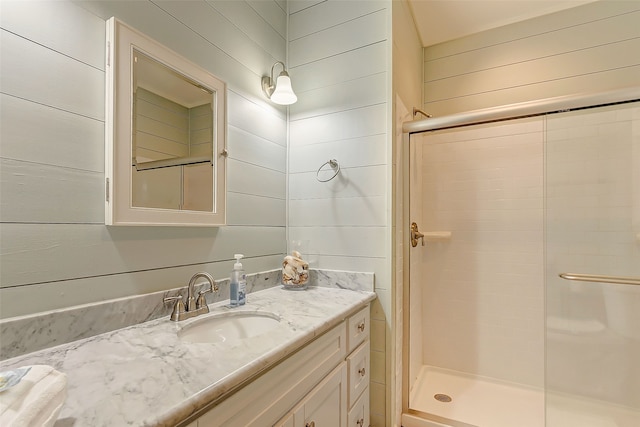 bathroom with a shower with door and oversized vanity