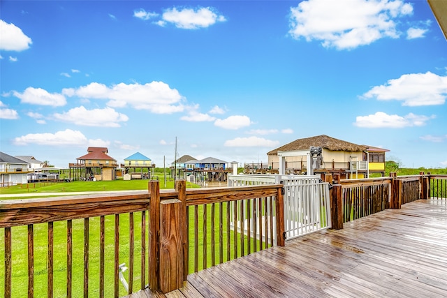 wooden terrace with a lawn and a gazebo