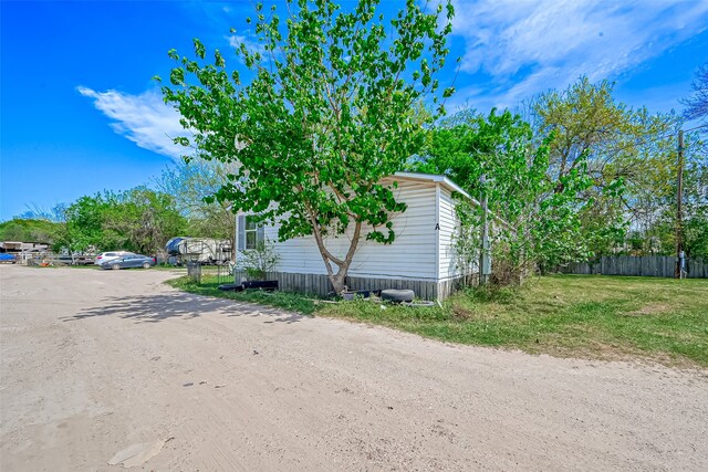 view of side of property with a yard