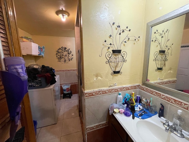 bathroom with large vanity, tile walls, washer / clothes dryer, backsplash, and tile flooring