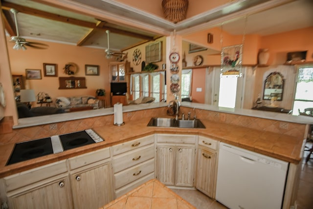 kitchen with light tile flooring, ceiling fan, kitchen peninsula, dishwasher, and sink