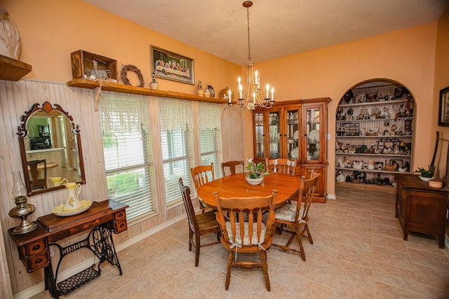 tiled dining area featuring a notable chandelier