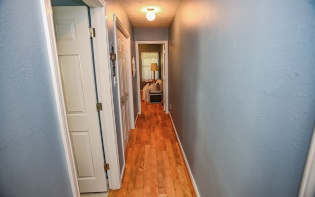 hallway with light wood-type flooring