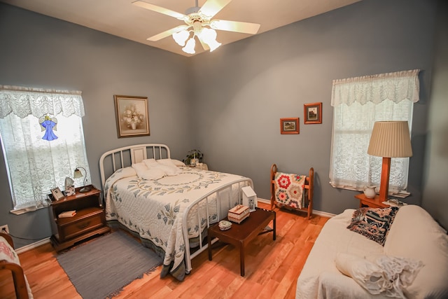 bedroom with ceiling fan and light wood-type flooring