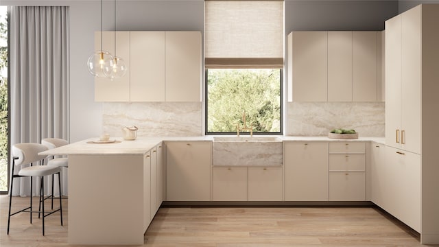 kitchen featuring kitchen peninsula, decorative light fixtures, white cabinets, and tasteful backsplash