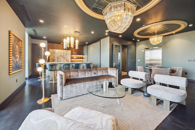 living area featuring a chandelier, recessed lighting, wood finished floors, and baseboards