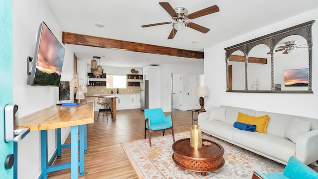 living room featuring ceiling fan and light hardwood / wood-style flooring