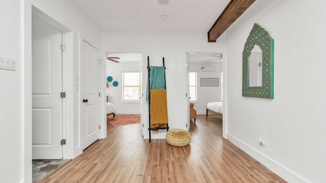 interior space featuring light hardwood / wood-style flooring and beam ceiling