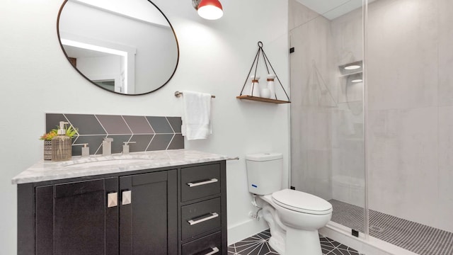 bathroom featuring tile flooring, vanity, toilet, and a shower with shower door