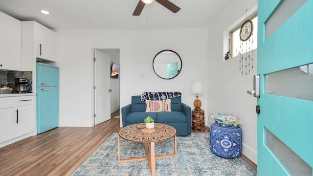 living room with ceiling fan and light hardwood / wood-style floors