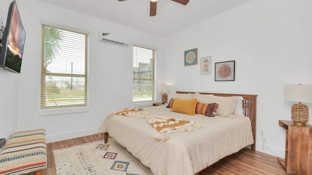 bedroom featuring ceiling fan, light hardwood / wood-style floors, and multiple windows