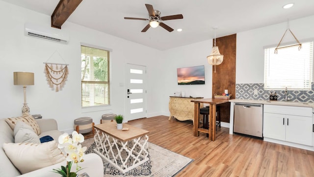 living room with ceiling fan, beamed ceiling, a wall mounted air conditioner, light wood-type flooring, and sink