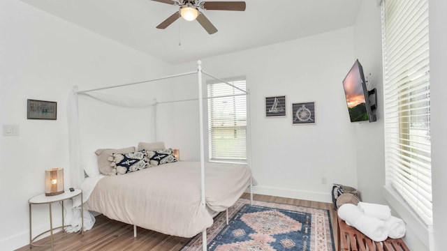 bedroom with ceiling fan and dark hardwood / wood-style floors