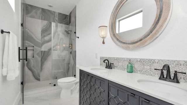 bathroom featuring double sink, backsplash, toilet, a shower with shower door, and large vanity