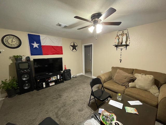 living room featuring carpet flooring, a textured ceiling, and ceiling fan