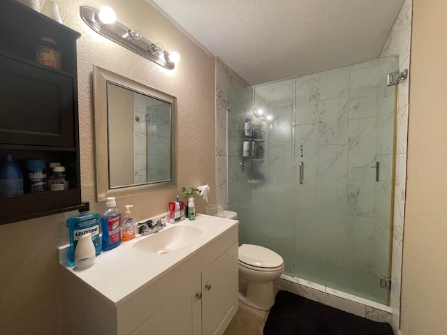 bathroom featuring oversized vanity, toilet, a textured ceiling, and a shower with shower door