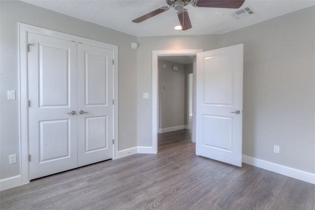 unfurnished bedroom with a closet, ceiling fan, and wood-type flooring