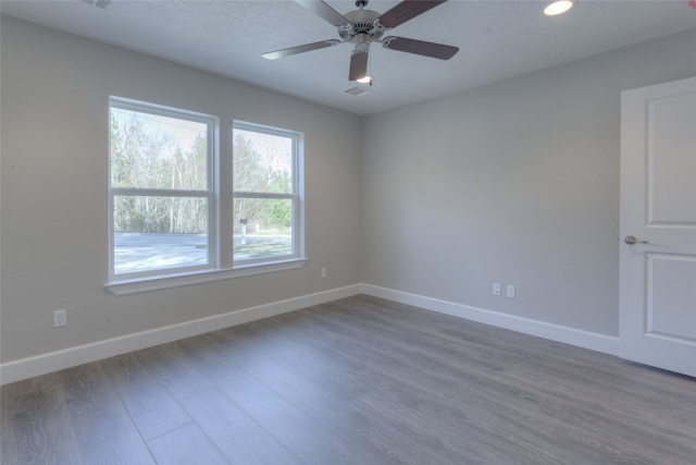 unfurnished room featuring ceiling fan and dark hardwood / wood-style floors