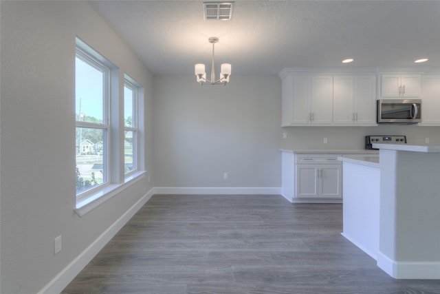 kitchen featuring a chandelier, hanging light fixtures, white cabinets, and dark hardwood / wood-style floors