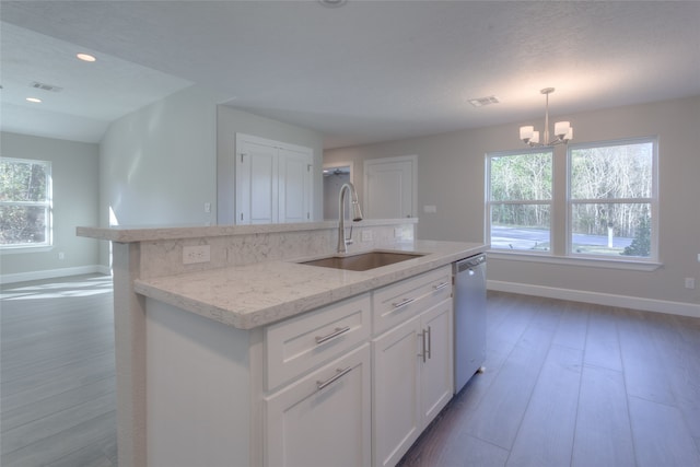 kitchen with decorative light fixtures, an inviting chandelier, dark wood-type flooring, white cabinets, and sink