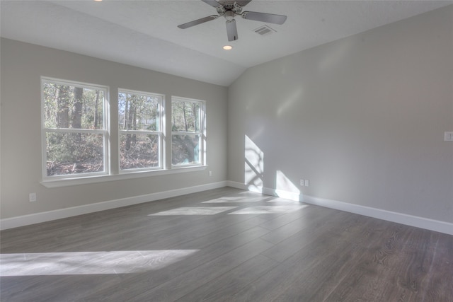 unfurnished room featuring vaulted ceiling, dark hardwood / wood-style flooring, and ceiling fan