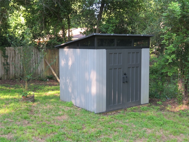 view of shed / structure with a lawn