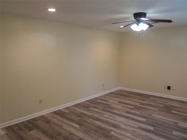 unfurnished room with dark hardwood / wood-style flooring and ceiling fan