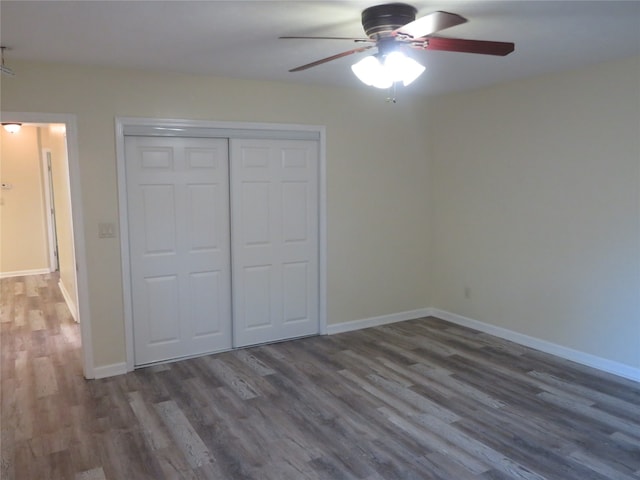 unfurnished bedroom featuring a closet, ceiling fan, and dark wood-type flooring