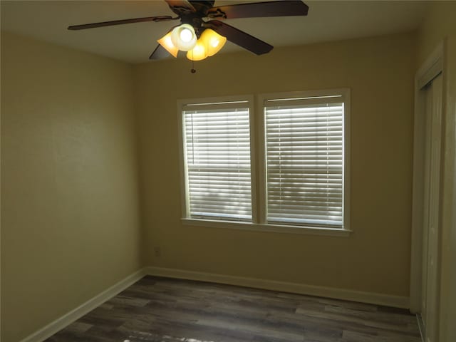 unfurnished room featuring dark hardwood / wood-style floors and ceiling fan