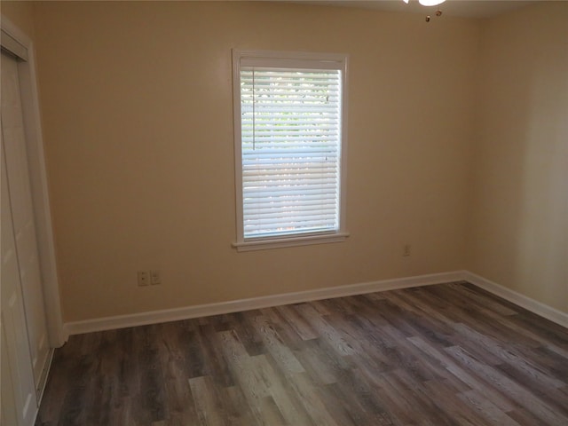 unfurnished room with dark hardwood / wood-style floors