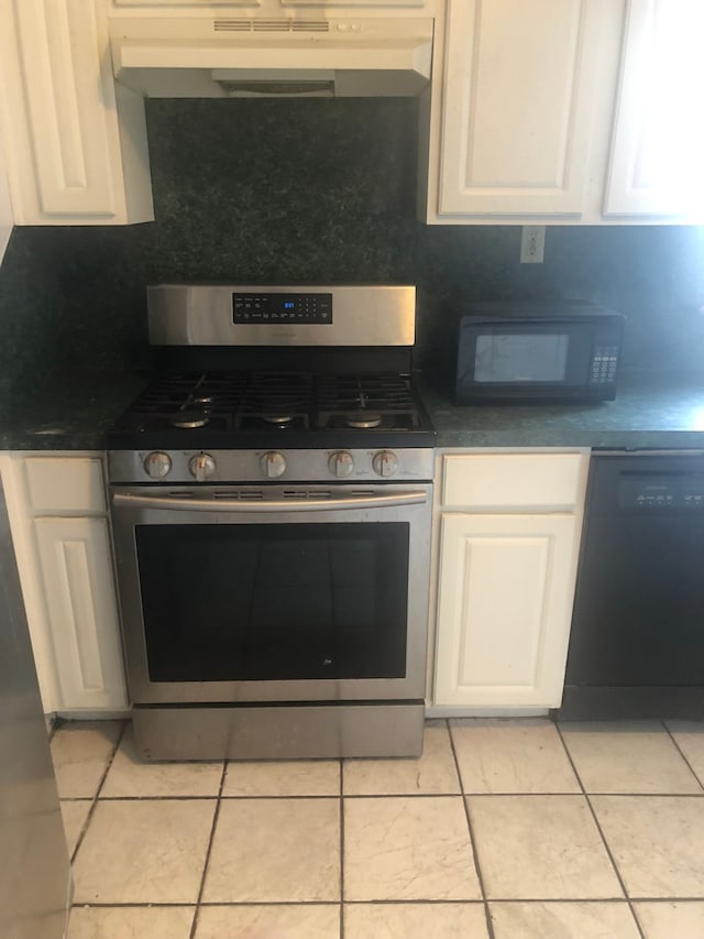 kitchen featuring light tile flooring, white cabinets, and black appliances